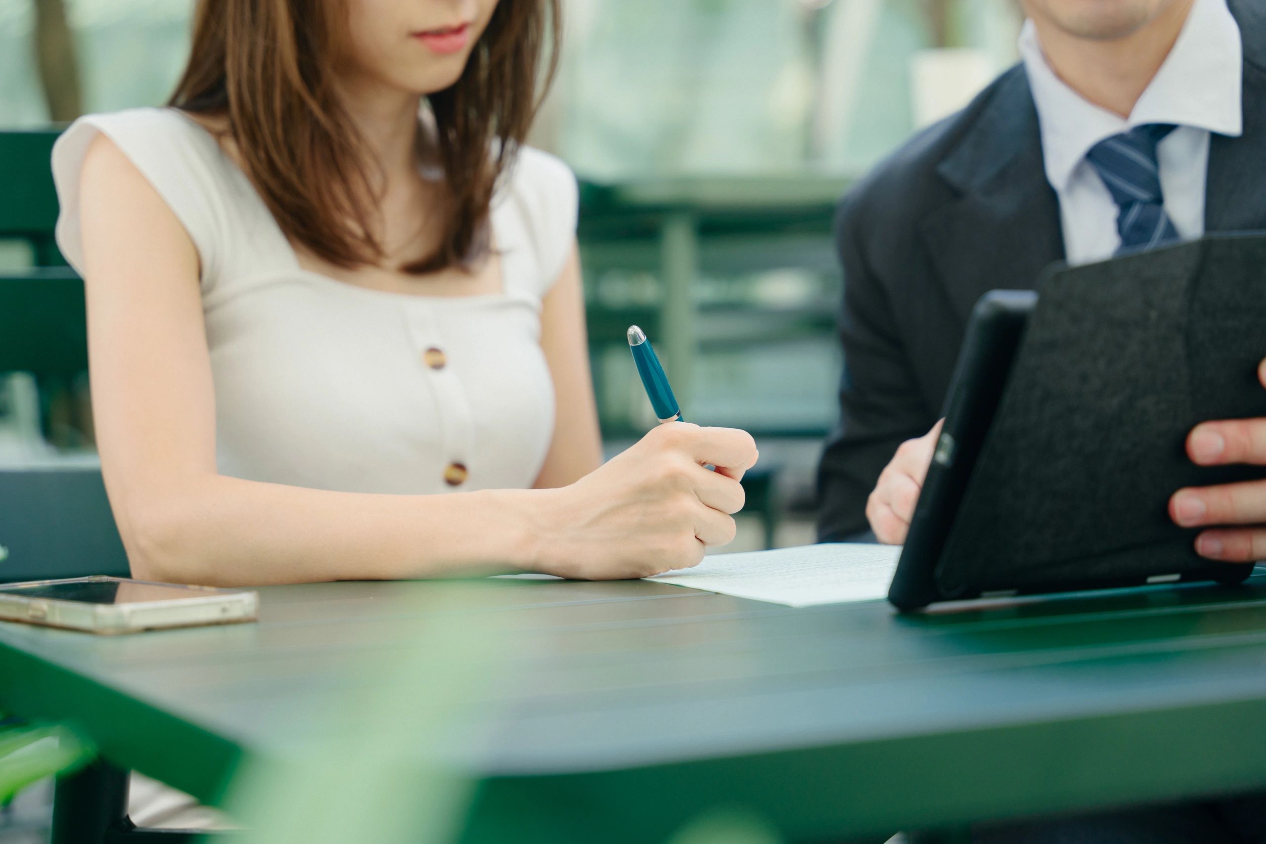 Insurance professional reviewing application documents with a client