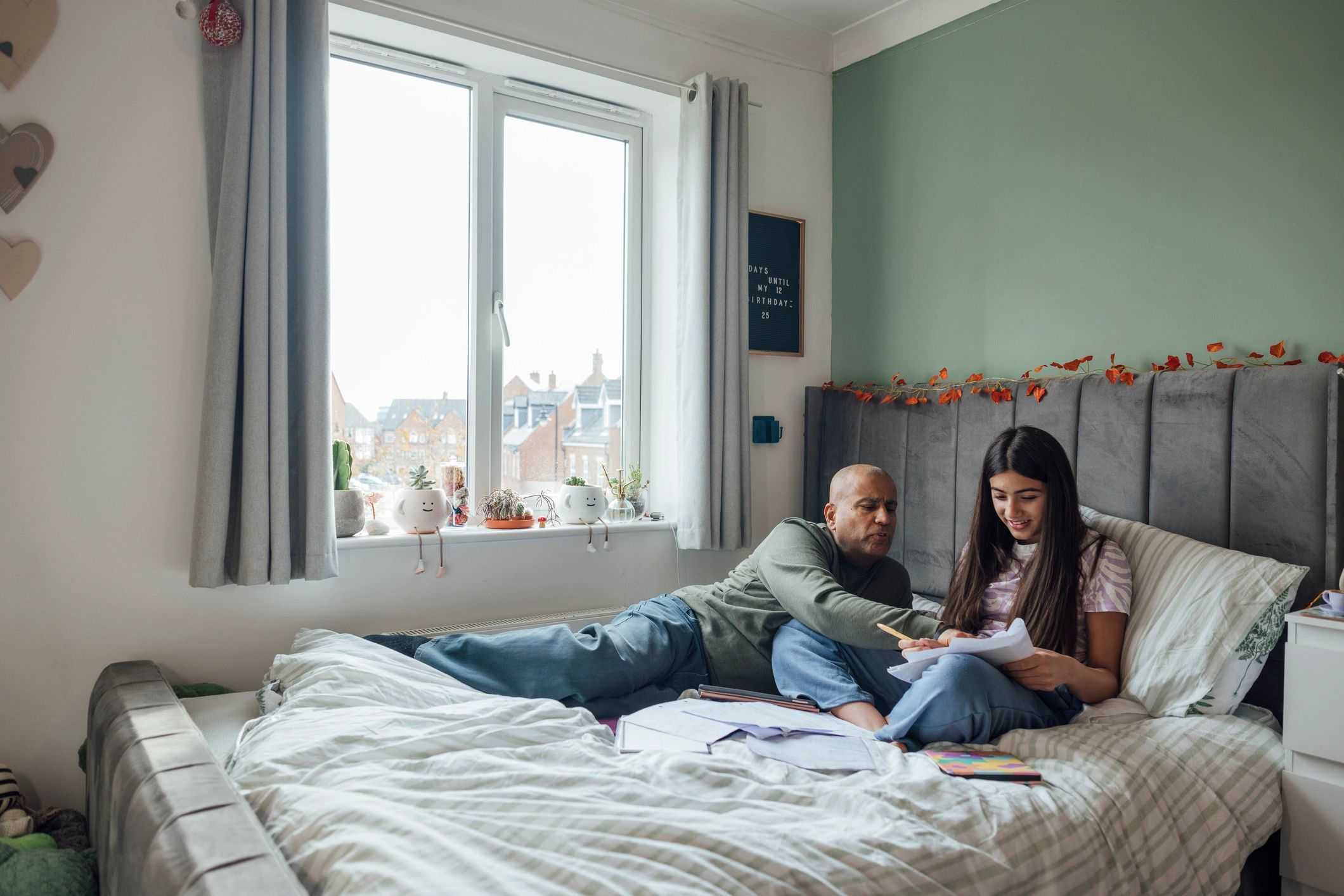 Parent and child reviewing paperwork together at home