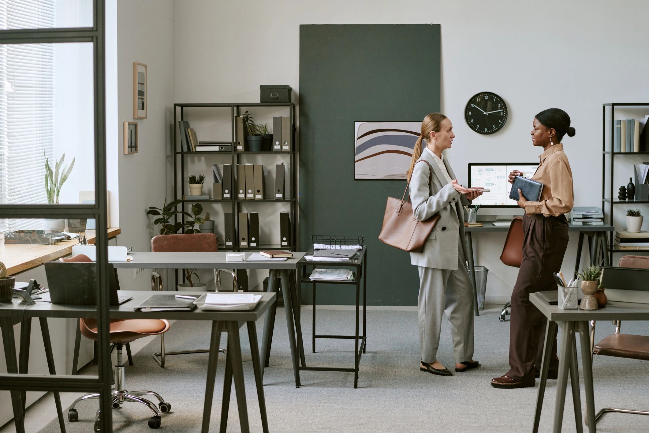 Two business owners discussing strategy in a modern office