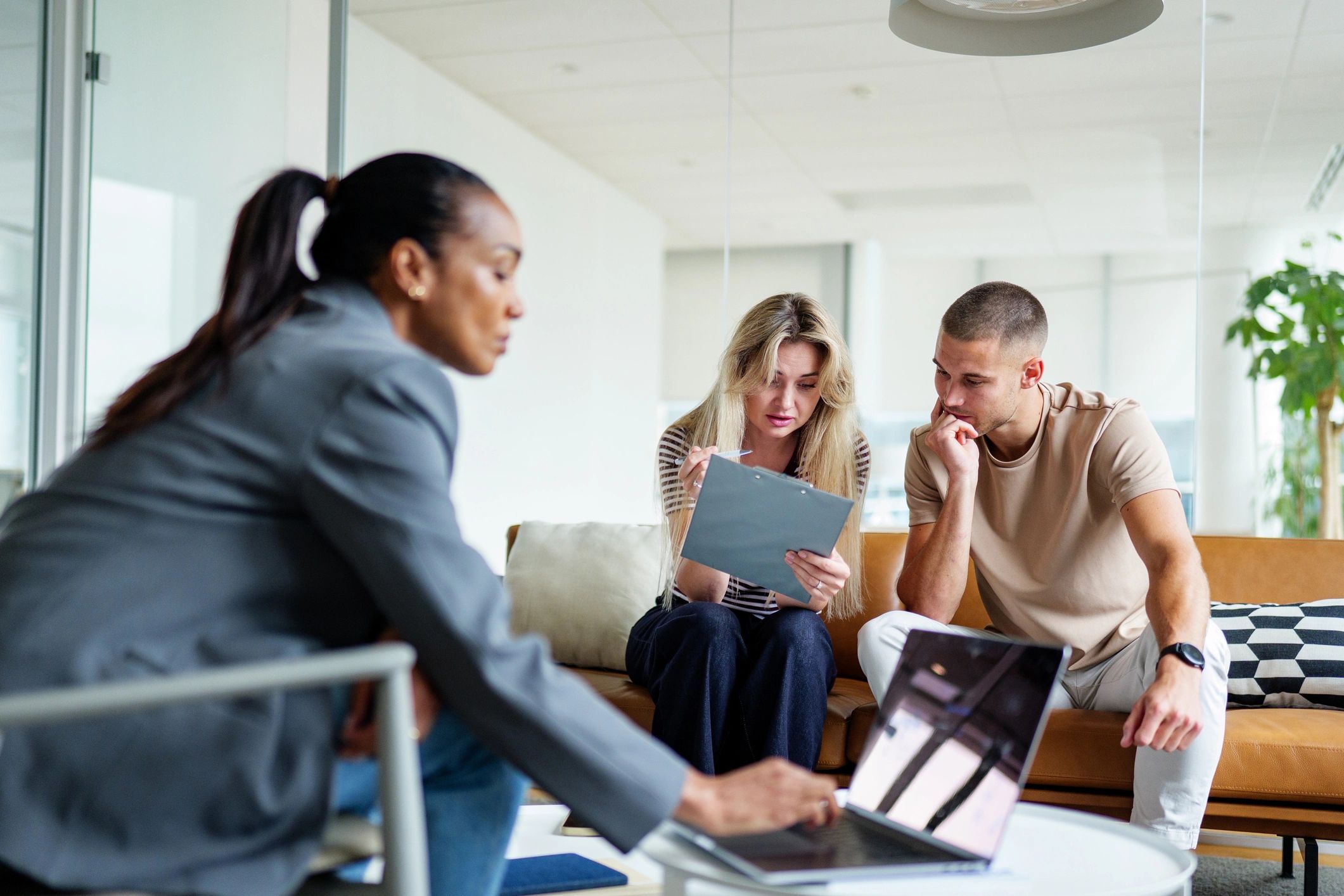 Couple reviewing insurance paperwork with an advisor