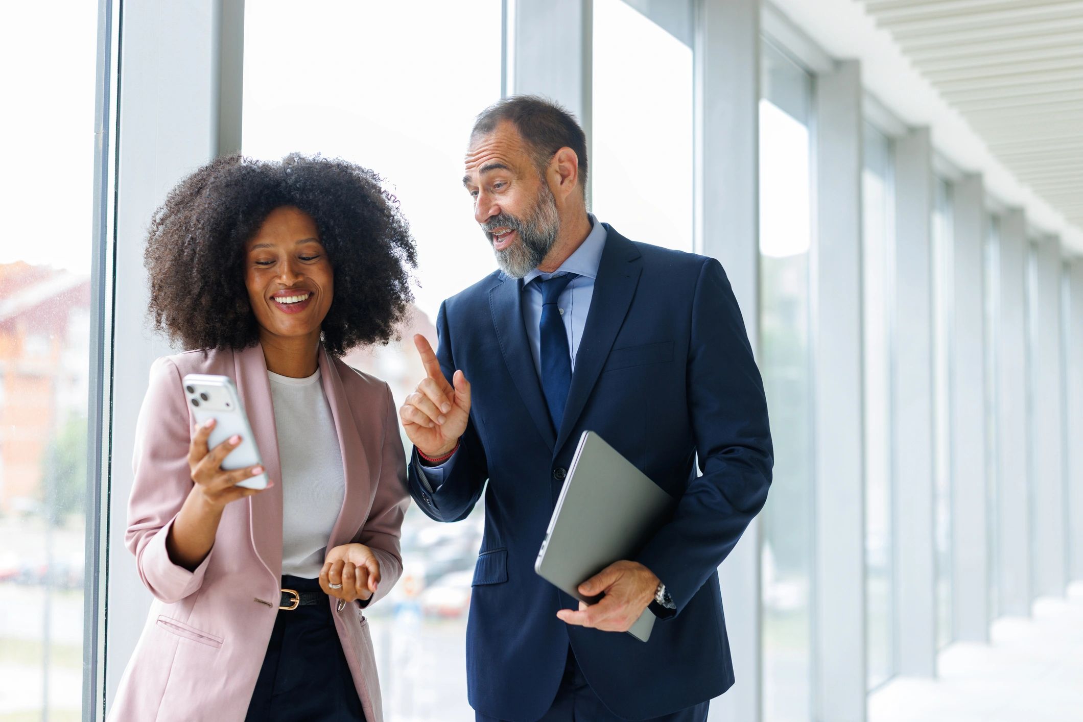 Two business colleagues reviewing information on a smartphone