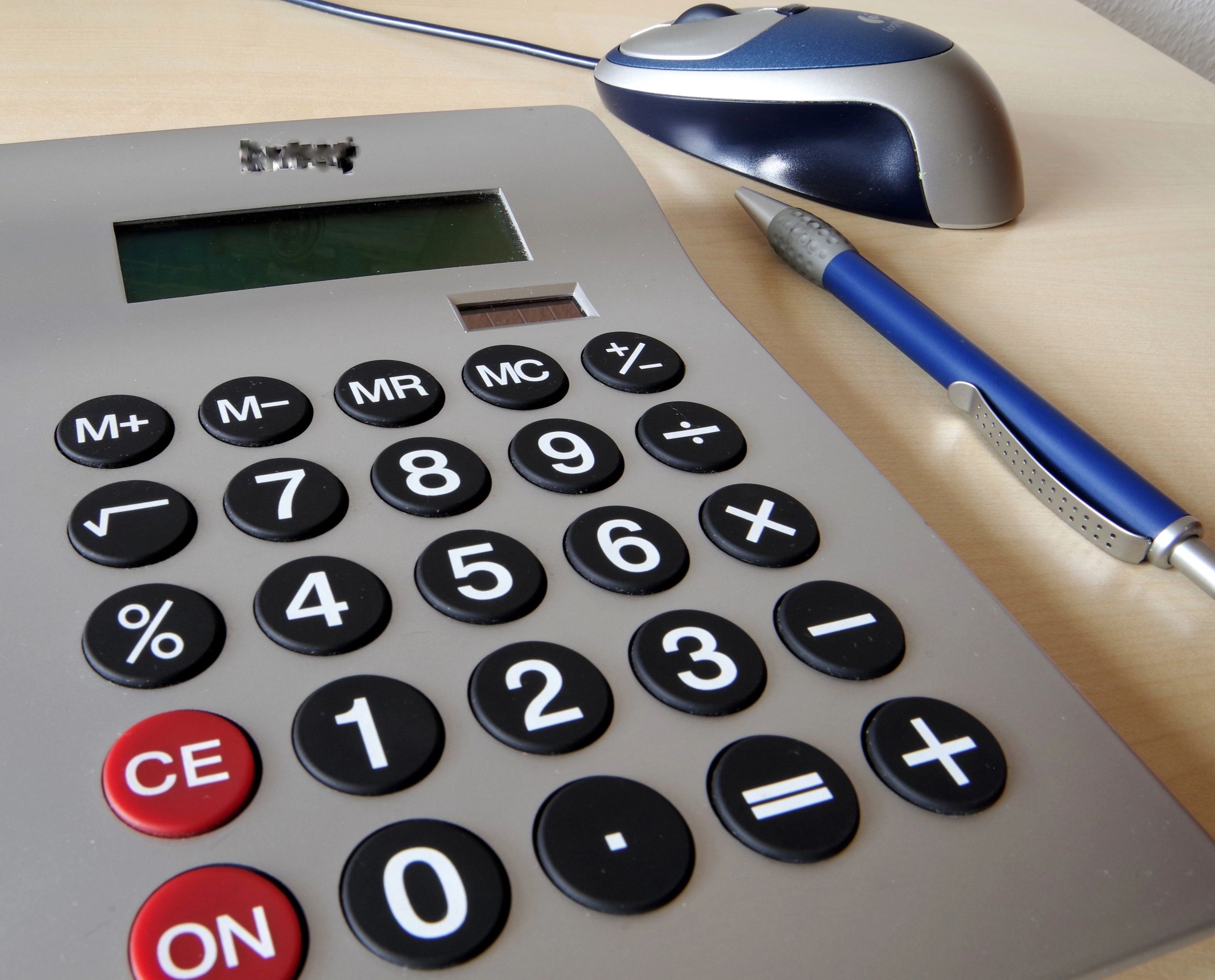 Calculator and pen for reviewing policy figures